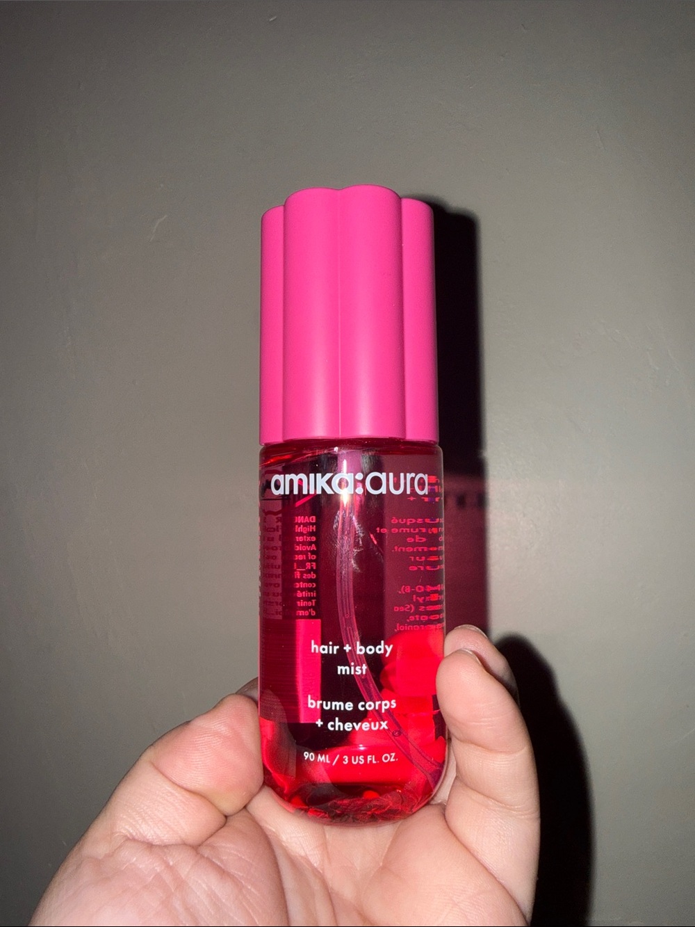 amika aura Hair + Body Mist in Bright Pink Bottle